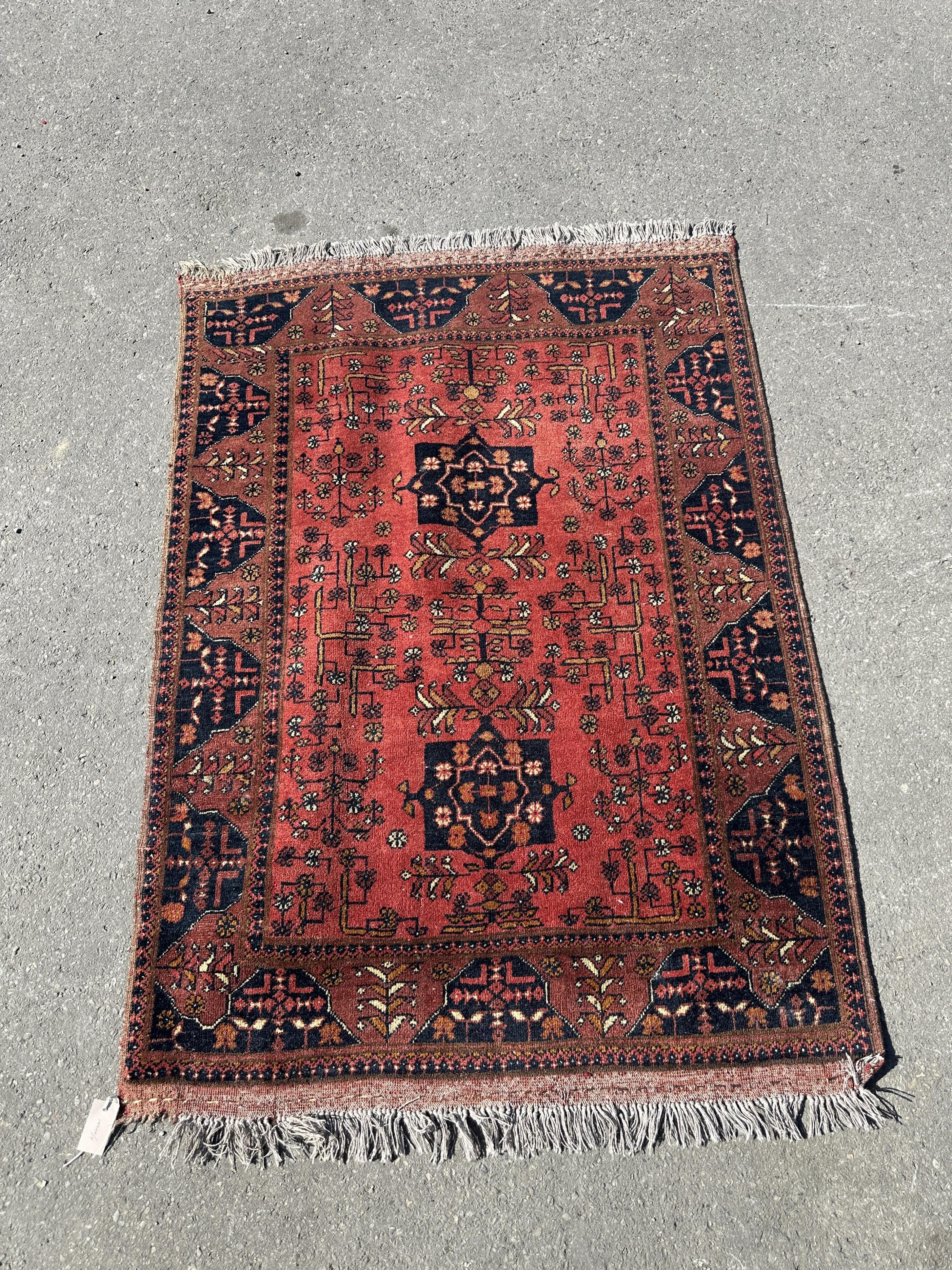 A Belouch red ground rug, 140 x 108cm